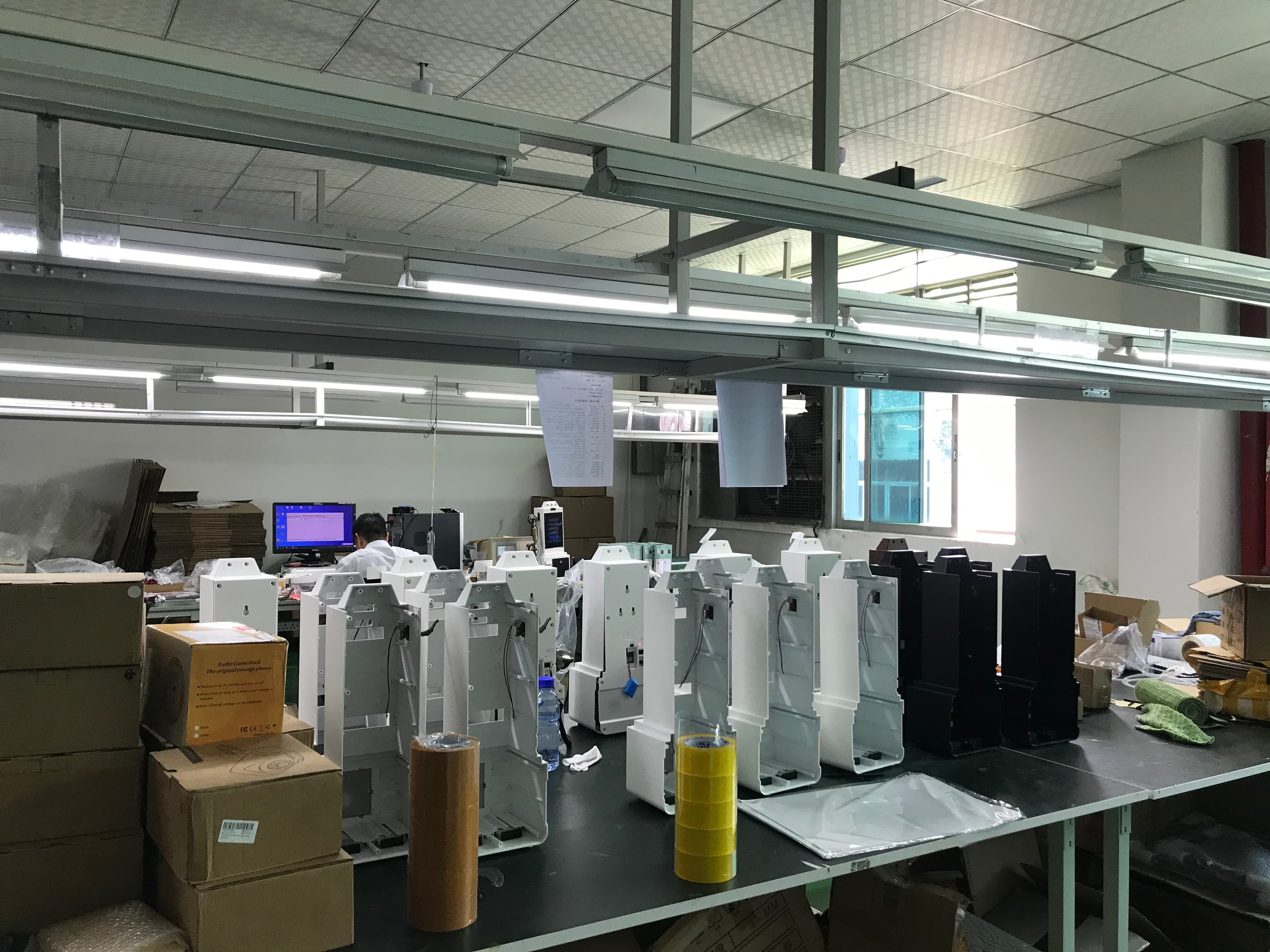 CHEETA audio guestbook payphone housings at an assembly workstation